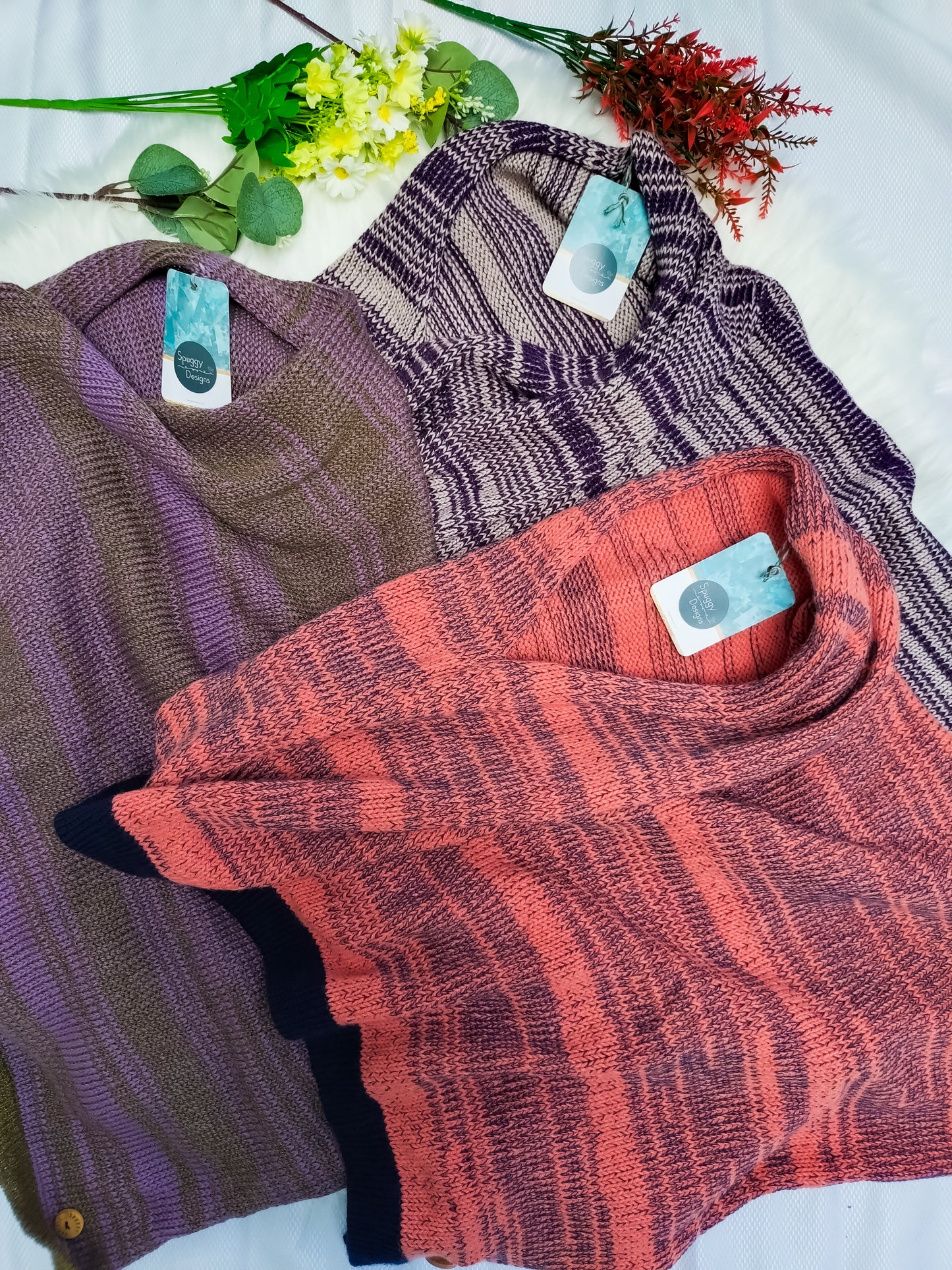 Flatlay photo of 3 handmade British & Merino wool scarves. colours include: Coral & Navy, Lilac purple & gold brown, Plum purple & beige