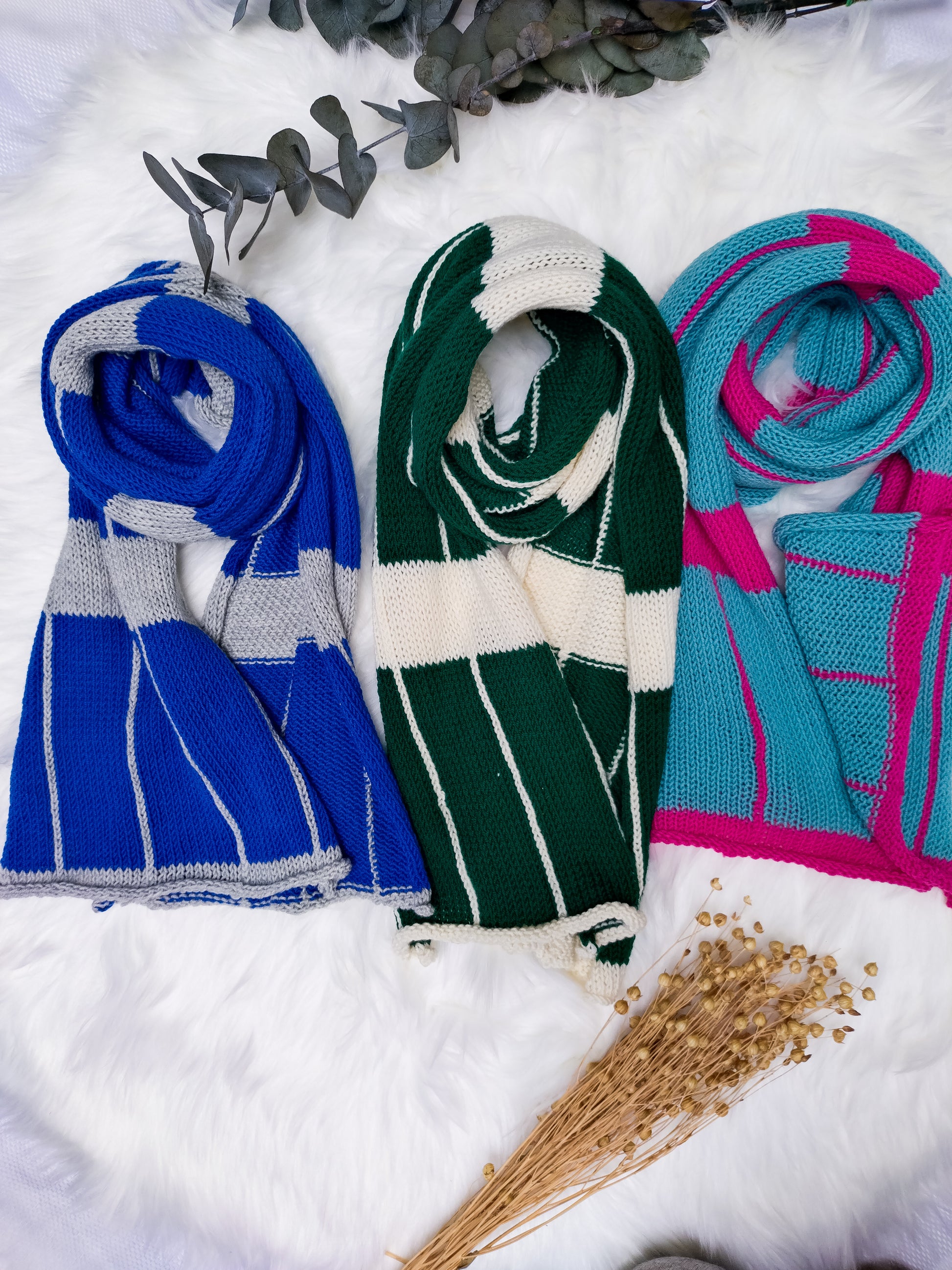 Flat lay photo of 3 Large Checkered Merino wool scarves. colours include: bottle green & cream, cobalt blue & silver grey, turquoise & magenta pink