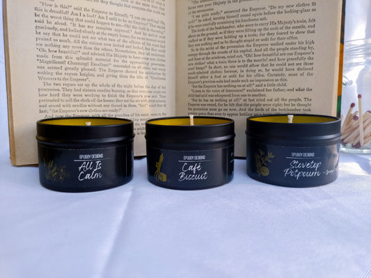 Three soy candles with labels in front of an open book